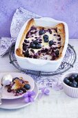 Berry casserole in a casserole dish and a small plate with a spoon