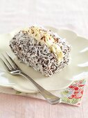 A lamington with buttercream (cake with chocolate glaze and dessicated coconut)