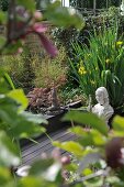 View of stone bust on wooden deck through leaves