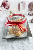 Jar of coconut macaroons on tray in artificial snow