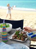 Grilled lamb chops with mint sauce on the beach