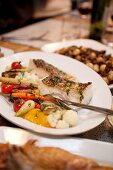 Sea Bass with Roasted Vegetables On Dinner Table