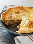 Chicken pie in a pie dish, sliced