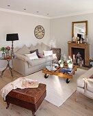 Leather ottoman and comfortable sofa around coffee table in corner of living room