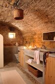 Bathroom counter with base unit in rustic bathroom with barrel vault ceiling