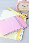 Notebook or diary decorated with tape, romantic retro alarm clock and felt-tip pen