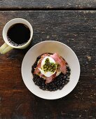 Steak and Eggs Over Black Beans; Topped with Sour Cream and Pesto; Cup of Coffee