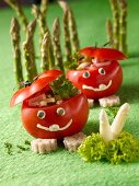 Funny tomato men in an asparagus forest