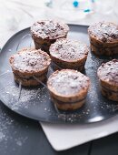 Mini Christmas puddings dusted with icing sugar