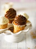 Various cupcakes on a cake stand