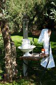 Ceramic washbasin and jug on chair in garden