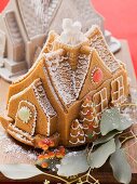 A gingerbread house with the baking tin in the background