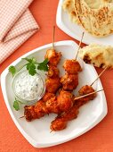 Chicken kebabs with a herb dip and unleavened bread