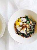 Braised lettuce with anchovies and a poached egg