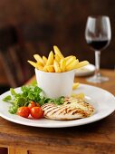 Chicken breast with garlic, chips and a glass of red wine
