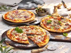 Three different stone oven pizzas