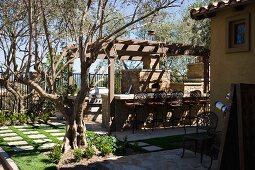 Tuscan backyard patio with grill and bar