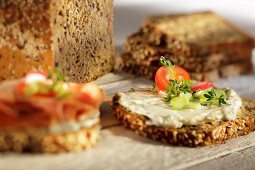 Slices of wholemeal bread topped with herb quark and vegetables