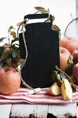 A blackboard with chalk and fresh apples