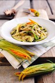 Fresh egg tagliolini with sliced courgettes and courgette flowers