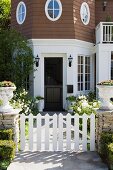 White gate and sidewalk leading to front entrance