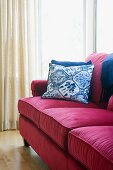 Red sofa with blue accent throw pillows