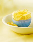Lemon Souffle with Sliced Candied Lemons and Lemon Peel in a Blue Bowl