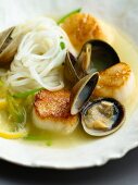 A Serving of Clams and Scallops with Noodles in a Lemon Wine Sauce