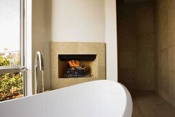Stand Alone Bathtub in Front of Fireplace