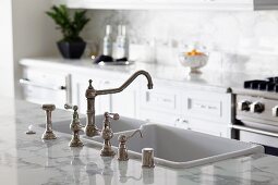 Chrome faucet and apron kitchen sink in contemporary kitchen