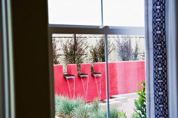 View of contemporary fountain through window