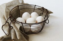 White eggs in a wire basket