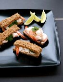 Finger sandwiches with prawns, mayonnaise and coriander