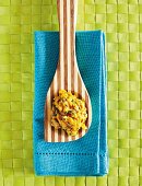 Spinach and coconut daal on a wooden spoon (India)
