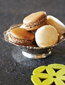Macaroons filled with chocolate and coconut cream in a silver dish