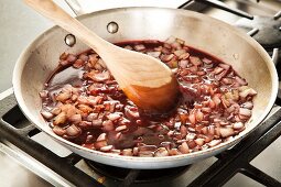 Stirring Wine into Sauteed Onions to Add to Beef Stew
