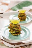Stacked courgette fritters with lime wedges