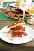 Corn fritters (deep-fried corncakes) with bacon and syrup