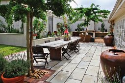 Large pieces of wood used as a table on a patio