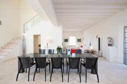 Black dining table in modern white interior