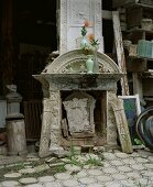 Antique fireplace stored in open, barn-like room