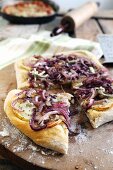 Pizza topped with gorgonzola cheese, red onions and apple slices