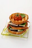 A mini club sandwich with aubergines, cheese and ham