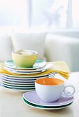 Teacups and stacked plates on table