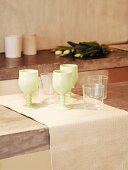 Painted wine glasses and water glasses on runner on concrete slab