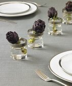 Table Setting with Artichokes in Glasses of Water