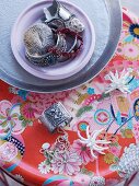 Jewellery on table with Oriental-style, floral surface