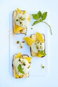 Shortbread topped with mango and a dollop of pistachio cream