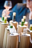 Blind wine tasting with wrapped up wine bottles