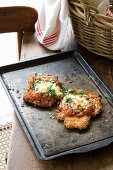 Parmigiana di pollo (chicken breast fillets with tomatoes and cheese)